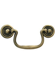 Swan-Neck Brass Bail Pull with Ringed Round Rosettes ‚Äì 3 ¬Ω‚Äù Center-to-Center in Antique Brass Finish.